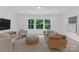 Living room with a beautiful view from the three large windows at 18238 Youngblood N Rd, Charlotte, NC 28278