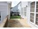 Sideyard backyard with a wooden fence, patio set, grill, and green grass at 19834 Davidson Concord Rd, Davidson, NC 28036