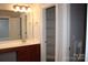 Bathroom featuring vanity with drawers, mirror, and walk-in closet with shelving at 19834 Davidson Concord Rd, Davidson, NC 28036