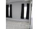 Bright bedroom featuring plush carpeting, two windows with black curtains, and neutral wall paint at 19834 Davidson Concord Rd, Davidson, NC 28036