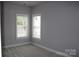 Bedroom featuring two windows with blinds and plush carpeting at 19834 Davidson Concord Rd, Davidson, NC 28036