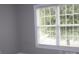 Bright bedroom with fresh paint and a large window providing natural light at 19834 Davidson Concord Rd, Davidson, NC 28036