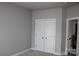 Neutral-toned bedroom showing a double door closet and carpeting at 19834 Davidson Concord Rd, Davidson, NC 28036