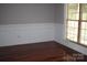 Hardwood floors and natural light create a soothing atmosphere in this bedroom at 19834 Davidson Concord Rd, Davidson, NC 28036