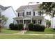 Charming two-story home with a welcoming front porch, manicured bushes and black shutters at 19834 Davidson Concord Rd, Davidson, NC 28036
