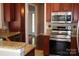 Cozy kitchen with stainless steel appliances, granite counters, and dark wood cabinetry at 19834 Davidson Concord Rd, Davidson, NC 28036