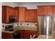 Cozy kitchen with stainless steel appliances, granite counters, and dark wood cabinetry at 19834 Davidson Concord Rd, Davidson, NC 28036