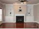 Spacious living room with hardwood floors, fireplace and built-in shelving on either side at 19834 Davidson Concord Rd, Davidson, NC 28036