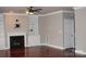 Spacious living room with hardwood floors, fireplace and built-in shelving on either side at 19834 Davidson Concord Rd, Davidson, NC 28036