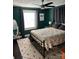 Stylish bedroom with dark green walls, a comfortable bed, patterned bedding, and a modern area rug at 199 Crowell Sw Dr, Concord, NC 28025