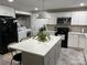 Well-lit kitchen featuring white cabinets, stainless steel appliances, a large island, and modern countertops at 199 Crowell Sw Dr, Concord, NC 28025