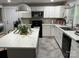 Bright kitchen boasts white cabinets, stainless steel appliances, a spacious island, and modern countertops at 199 Crowell Sw Dr, Concord, NC 28025