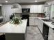 Well-lit kitchen featuring white cabinets, stainless steel appliances, a large island, and modern countertops at 199 Crowell Sw Dr, Concord, NC 28025
