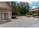 Charming outdoor space with a covered area, fire pit, brick patio, and meticulously maintained landscaping at 2031 Brook View Ct, Matthews, NC 28104