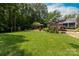 Expansive backyard with lush green lawn, mature trees, and a well-maintained garden, ideal for outdoor activities at 2031 Brook View Ct, Matthews, NC 28104