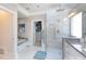 Bright bathroom featuring a soaking tub, glass-enclosed shower, walk in closet and modern fixtures at 2031 Brook View Ct, Matthews, NC 28104