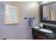 Elegant bathroom with dark vanity, granite countertop, decorative framed mirror, and artwork at 2031 Brook View Ct, Matthews, NC 28104
