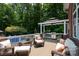 Outdoor deck area features a grill, outdoor seating, a gazebo, and a beautiful wooded view at 2031 Brook View Ct, Matthews, NC 28104