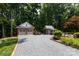 Long driveway leads to a brick garage and a smaller outbuilding providing ample parking and storage at 2031 Brook View Ct, Matthews, NC 28104