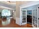 Open floor plan featuring large windows and hardwood floors, seamlessly connects living room to office at 2031 Brook View Ct, Matthews, NC 28104