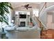 Open-concept living room with large sofa, fireplace, built-in shelves, and natural light at 2031 Brook View Ct, Matthews, NC 28104
