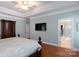 Light-filled main bedroom with hardwood floors, tray ceilings, with an ensuite bathroom and walk in closet at 2031 Brook View Ct, Matthews, NC 28104