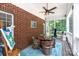 A screened porch provides a cozy outdoor living space, with a round table and comfortable seating at 2031 Brook View Ct, Matthews, NC 28104