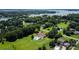 Expansive aerial view showcasing a home with a pool, set amid lush greenery and serene lakeside scenery at 205 Harwell Rd, Mooresville, NC 28117