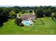 Aerial view of a home featuring a sparkling blue swimming pool, spacious backyard, and lush green surroundings at 205 Harwell Rd, Mooresville, NC 28117