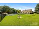 Expansive backyard featuring a pool, mature trees, and manicured lawn, perfect for outdoor enjoyment at 205 Harwell Rd, Mooresville, NC 28117