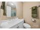 Well-lit bathroom featuring a white vanity, modern fixtures, and a glass-enclosed shower with tiled walls at 205 Harwell Rd, Mooresville, NC 28117
