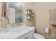 Bright white bathroom with a white vanity, modern fixtures and a glass shower at 205 Harwell Rd, Mooresville, NC 28117
