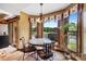 Cozy breakfast nook featuring large windows with outdoor views and a wrought-iron table and chairs at 205 Harwell Rd, Mooresville, NC 28117