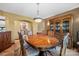 Dining room featuring wooden furniture, chandelier lighting, and a glimpse of an adjacent, modern kitchen at 205 Harwell Rd, Mooresville, NC 28117