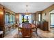 Formal dining room with hardwood table set, chandelier, and large hutch with view of landscaped yard at 205 Harwell Rd, Mooresville, NC 28117