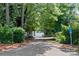 Private driveway leading to waterfront access, surrounded by lush greenery and mature trees at 205 Harwell Rd, Mooresville, NC 28117
