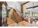 Grand foyer with staircase and views into the living room with fireplace and wood beams at 205 Harwell Rd, Mooresville, NC 28117