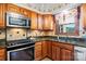 Bright kitchen showcasing wooden cabinets, stainless steel appliances, and a window view at 205 Harwell Rd, Mooresville, NC 28117