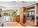Open kitchen with wooden cabinetry, granite countertops, and tiled flooring, connected to dining and living areas at 205 Harwell Rd, Mooresville, NC 28117