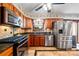 Well-lit kitchen featuring stainless steel appliances, granite countertops, and wood cabinetry at 205 Harwell Rd, Mooresville, NC 28117