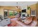 Cozy living room featuring a fireplace, comfortable seating, and large windows overlooking the garden at 205 Harwell Rd, Mooresville, NC 28117
