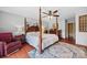 Bright main bedroom with a four-poster bed, ceiling fan, and hardwood floors at 205 Harwell Rd, Mooresville, NC 28117