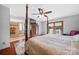 A main bedroom with four-poster bed, ceiling fan, dresser with TV and view into the shower at 205 Harwell Rd, Mooresville, NC 28117