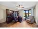 Office with wood floors, custom shelves and cabinets, ceiling fan and natural light from the window at 205 Harwell Rd, Mooresville, NC 28117