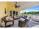 Relaxing outdoor covered patio with wicker furniture and a view of the green backyard at 205 Harwell Rd, Mooresville, NC 28117
