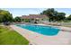 Large, inviting swimming pool with lounge chairs, surrounded by a white picket fence and green lawn at 205 Harwell Rd, Mooresville, NC 28117