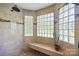 Shower room featuring stone tile and glass block window at 205 Harwell Rd, Mooresville, NC 28117
