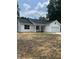 Attractive one-story home featuring white siding, a dark roof, and tidy landscaping in the front yard at 210 Johnson St, Troutman, NC 28116