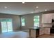 The bright kitchen boasts modern appliances, granite countertops, and a view of the backyard at 210 Johnson St, Troutman, NC 28116
