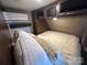 Cozy bedroom features overhead storage, comfortable bed, and climate control for a relaxing retreat at 217 Badin View Dr # B257, New London, NC 28127